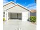 Open garage with storage space and concrete floor at 2219 Welcome Way, The Villages, FL 32162