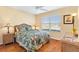 Cozy bedroom with hardwood floors and wicker furniture at 2304 Jonebury Run, The Villages, FL 32162