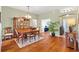 Bright dining room with hardwood floors and an elegant dining set at 2304 Jonebury Run, The Villages, FL 32162