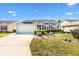 One story house with a landscaped lawn and attached garage at 2304 Jonebury Run, The Villages, FL 32162