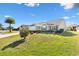 House exterior view showcasing a neatly landscaped front yard at 2304 Jonebury Run, The Villages, FL 32162