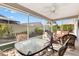 Enjoy this screened patio with outdoor furniture and ceiling fan at 2304 Jonebury Run, The Villages, FL 32162