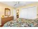 Main bedroom with wicker dresser and floral bedding at 2304 Jonesbury Run, The Villages, FL 32162