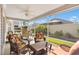 Relaxing screened porch with wicker furniture and ceiling fan at 2304 Jonesbury Run, The Villages, FL 32162