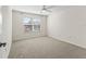 Well-lit bedroom with carpet and ceiling fan at 2338 Mcclellanville Ter, The Villages, FL 32162