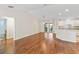 Dining room with hardwood floors and view of the kitchen and bathroom at 2338 Mcclellanville Ter, The Villages, FL 32162