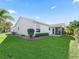 Exterior view of a single-story house with a screened patio and well-maintained lawn at 2338 Mcclellanville Ter, The Villages, FL 32162