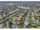 Aerial view of the neighborhood, showing the property's location near a lake at 2338 Mcclellanville Ter, The Villages, FL 32162