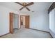 Bedroom with ceiling fan, closet, and access to another room at 2355 Lakeview Ave, Clermont, FL 34711