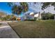 House exterior showcasing a two-story home with palm trees and a yard at 2355 Lakeview Ave, Clermont, FL 34711