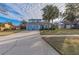 Front view of a two-story house with a light blue garage door at 2355 Lakeview Ave, Clermont, FL 34711