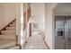 Staircase and hallway with tiled floors and stainless steel refrigerator at 2355 Lakeview Ave, Clermont, FL 34711