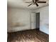 Bare bedroom shows wood-look floors, simple ceilings, and neutral paint at 2438 Centennial Blvd, Leesburg, FL 34748