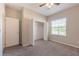 Bedroom with carpeted floor, ceiling fan and walk in closet at 24506 Woodhill Ct, Sorrento, FL 32776