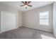 Spacious bedroom with ceiling fan and carpet at 24506 Woodhill Ct, Sorrento, FL 32776