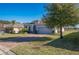 Landscaped one-story home features a gray exterior, paver driveway, and two-car garage at 24506 Woodhill Ct, Sorrento, FL 32776