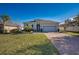 Curb appeal abounds at this one-story home with gray siding and paver driveway at 24506 Woodhill Ct, Sorrento, FL 32776