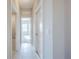 Bright hallway with tile floors and access to bedrooms at 24506 Woodhill Ct, Sorrento, FL 32776