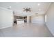 Bright and airy living room with tile floors and a view into the kitchen at 24506 Woodhill Ct, Sorrento, FL 32776