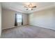 Main bedroom with tray ceiling, carpet and fan at 24506 Woodhill Ct, Sorrento, FL 32776