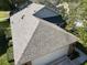 Housetop view showing gray asphalt shingle roof and attached garage at 24947 Cranes Roost Cir, Leesburg, FL 34748