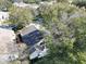 Aerial view of a house nestled amongst trees at 24947 Cranes Roost Cir, Leesburg, FL 34748