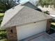 Aerial view highlighting gray asphalt shingle roof and garage at 24947 Cranes Roost Cir, Leesburg, FL 34748