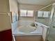 Bathroom with shower and separate garden tub at 24947 Cranes Roost Cir, Leesburg, FL 34748