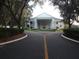 Grand clubhouse entrance with columns and landscaping at 24947 Cranes Roost Cir, Leesburg, FL 34748