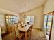 Dining room with light wood table and chairs, and built-in hutch at 24947 Cranes Roost Cir, Leesburg, FL 34748