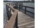 Wooden dock with bench overlooking a lake at 24947 Cranes Roost Cir, Leesburg, FL 34748