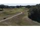 Aerial view of a golf course with homes in the background at 24947 Cranes Roost Cir, Leesburg, FL 34748