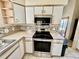 Kitchen with stainless steel range and microwave at 24947 Cranes Roost Cir, Leesburg, FL 34748