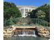 Small waterfall feature with a bridge and lush greenery at 24947 Cranes Roost Cir, Leesburg, FL 34748