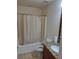 Clean bathroom with tub, toilet and granite vanity at 255 David Walker Dr # F5, Tavares, FL 32778