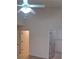 Primary bedroom with tile floor and ceiling fan at 255 David Walker Dr # F5, Tavares, FL 32778