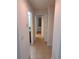 Bright hallway with tile flooring and access to bedrooms and bath at 255 David Walker Dr # F5, Tavares, FL 32778