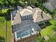 Aerial view showing house, pool, and solar panels at 25833 Feather Ridge Ln, Sorrento, FL 32776