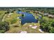 Aerial view of golf course with lake and homes at 25833 Feather Ridge Ln, Sorrento, FL 32776