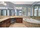 Elegant bathroom with double vanity, soaking tub, and shower at 25833 Feather Ridge Ln, Sorrento, FL 32776