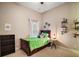 Small bedroom with twin bed and industrial shelving at 25833 Feather Ridge Ln, Sorrento, FL 32776