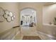 Bright and spacious entryway with elegant mirror and console table at 25833 Feather Ridge Ln, Sorrento, FL 32776