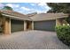 Two-car garage with paver driveway at 25833 Feather Ridge Ln, Sorrento, FL 32776