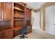 Home office with built-in desk and cabinets at 25833 Feather Ridge Ln, Sorrento, FL 32776