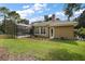 Backyard view of house with pool and screened enclosure at 25833 Feather Ridge Ln, Sorrento, FL 32776