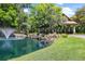 Pond with fountain at community entrance at 25833 Feather Ridge Ln, Sorrento, FL 32776