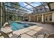 Spacious screened pool and spa with patio and outdoor seating at 25833 Feather Ridge Ln, Sorrento, FL 32776