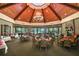 Elegant clubhouse restaurant with a fireplace and large windows at 25833 Feather Ridge Ln, Sorrento, FL 32776