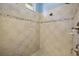 Large walk-in shower with diamond patterned tile at 25833 Feather Ridge Ln, Sorrento, FL 32776