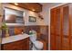 Updated bathroom with wood vanity, slate tile, and built-in shelving at 2614 W Ponkan Rd, Apopka, FL 32712